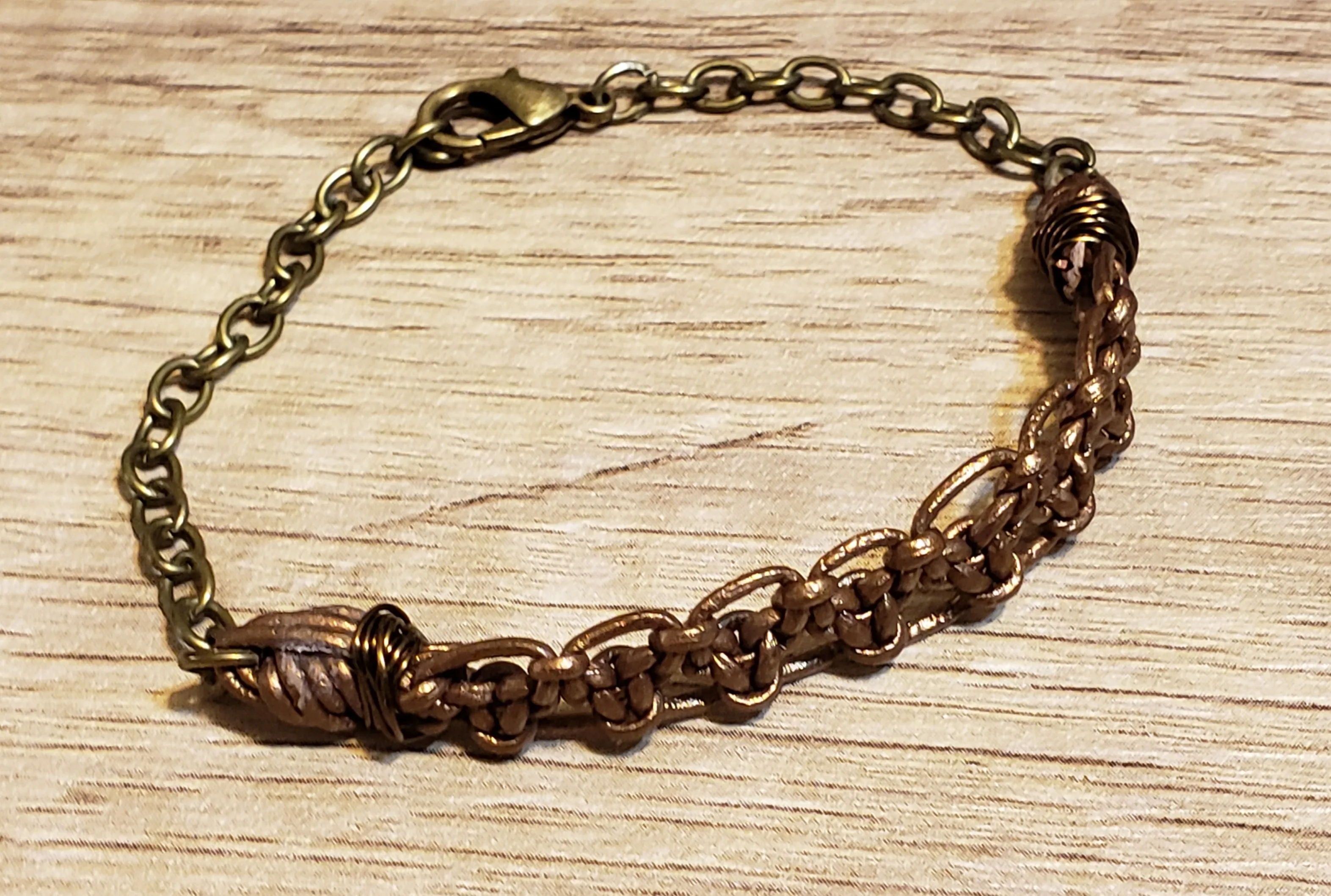 Metallic Bronze Leather Bracelet & Gold Tone Stainless Steel Chain, Adjustable up to 8" with Lobster Claw Clasp.
 