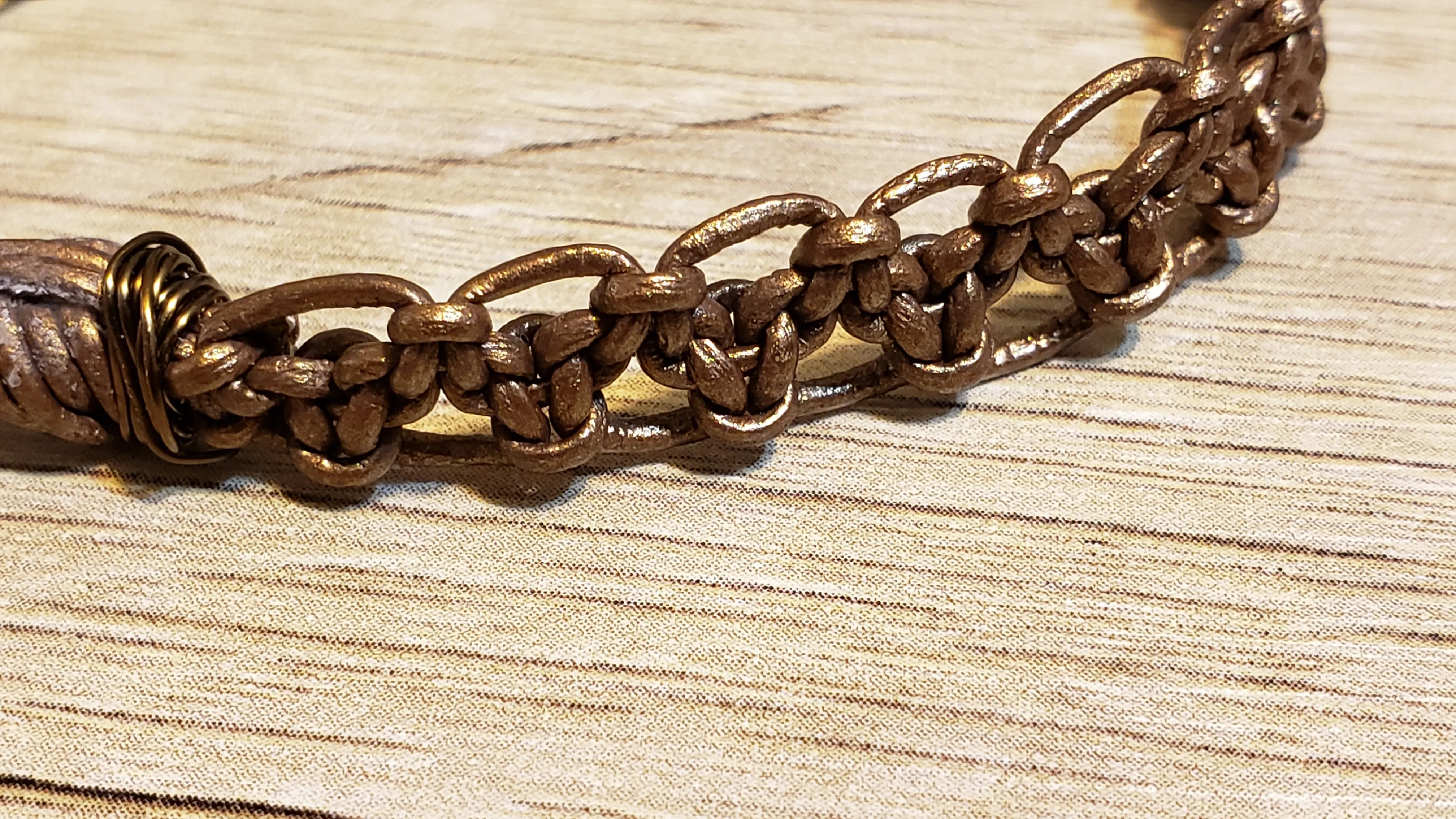 Metallic Bronze Leather Bracelet & Gold Tone Stainless Steel Chain, Adjustable up to 8" with Lobster Claw Clasp.
 