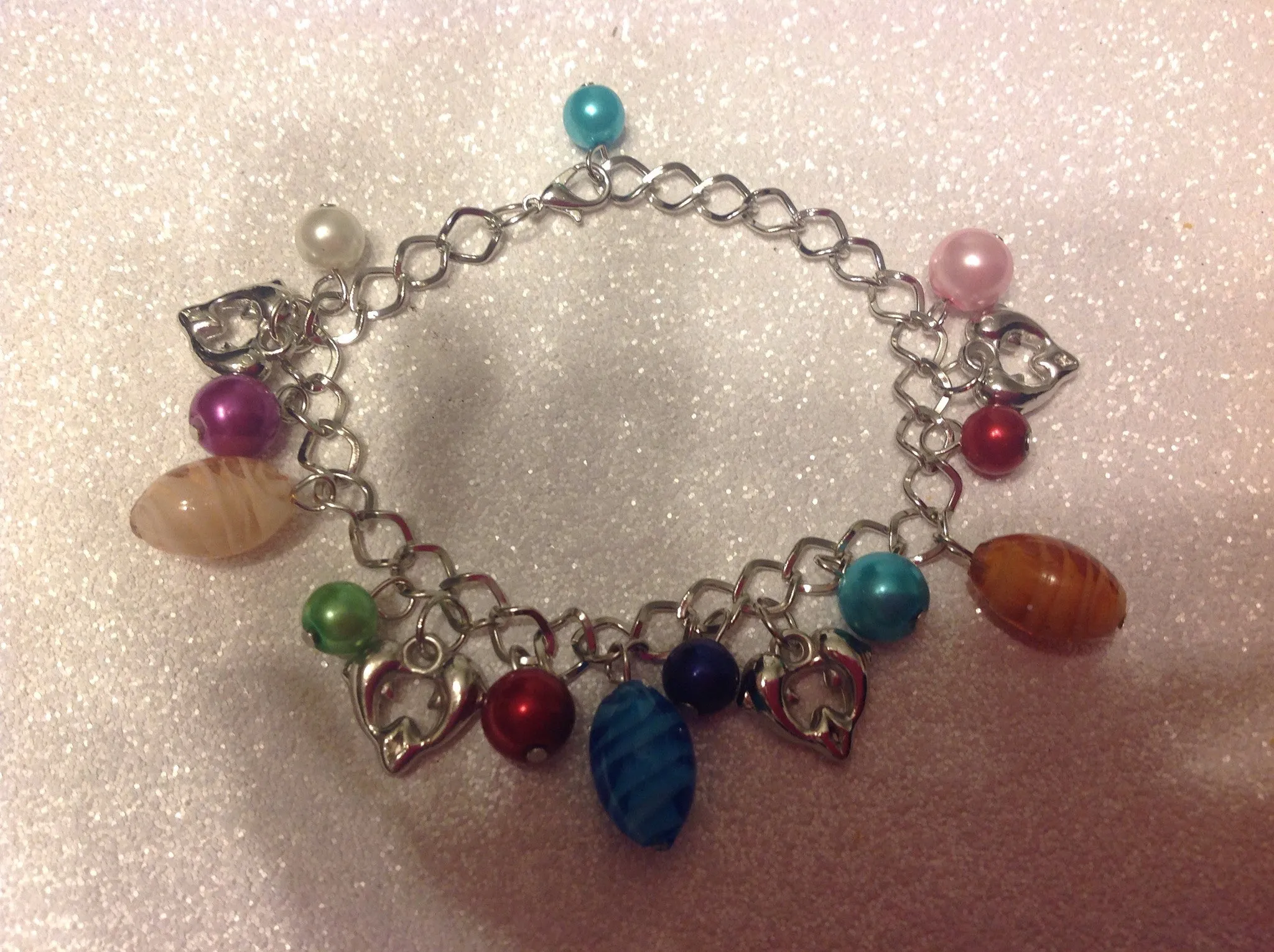 Silvertone dolphin charm bracelet.